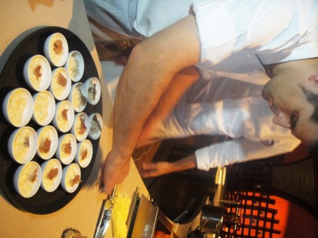 A sous chef from Ronda Locatelli shaves truffle onto risotto