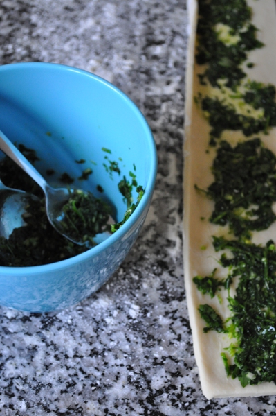 Rolled out dough and parsley and garlic filling