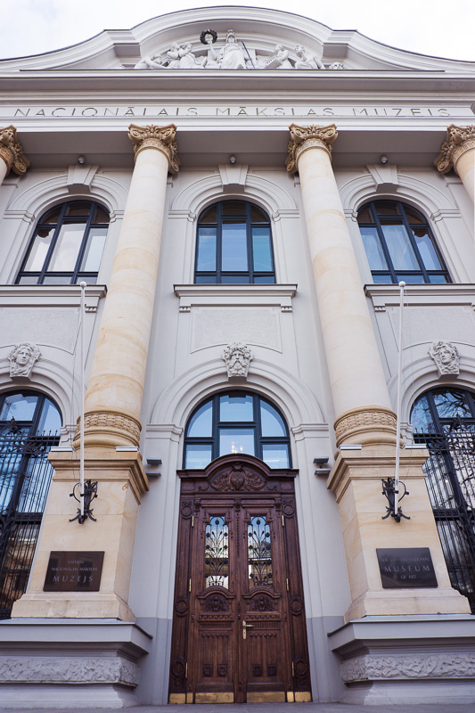Front of imposing building with wooden front door