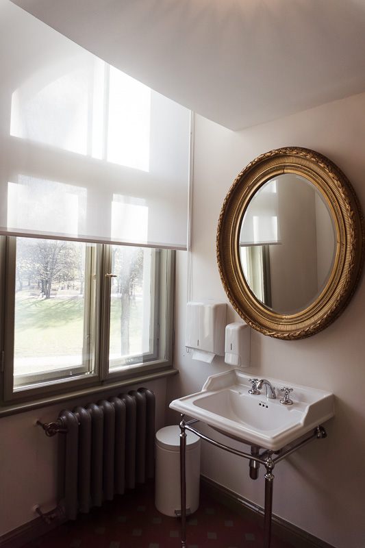 a sink and mirror by a window