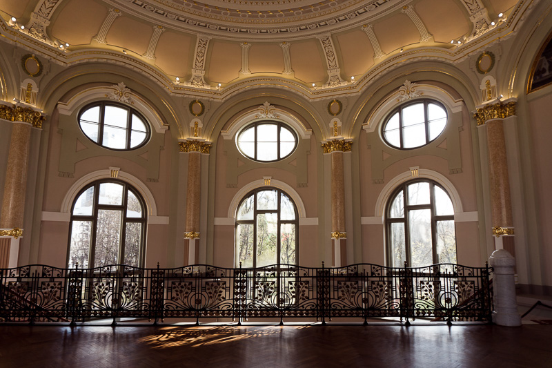 Curved Regency style windows and a balcony inside the second floor of the art gallery