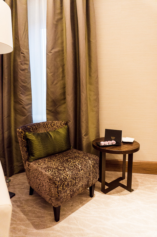 Table and chair in front of curtains