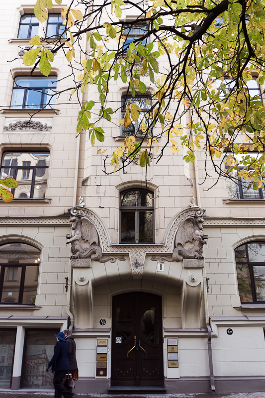 art nouveau decoration on house behind tree in riga