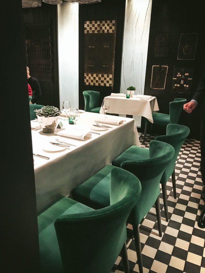 table and green chairs in restaurant