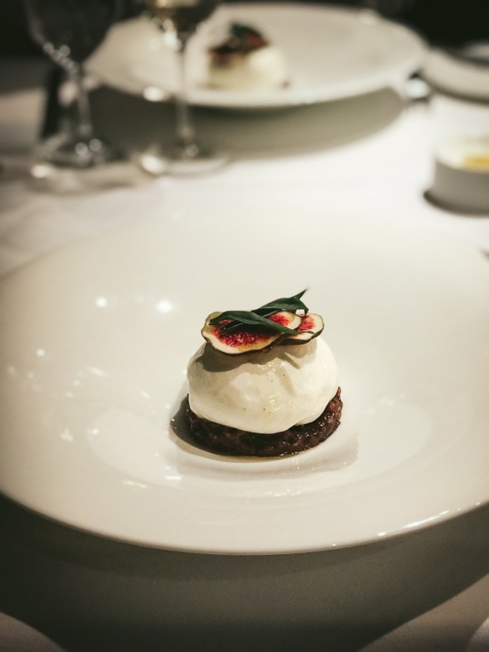 burrata cheese with figs on top on plate