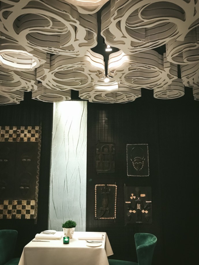 table under ornate ceiling in restaurant