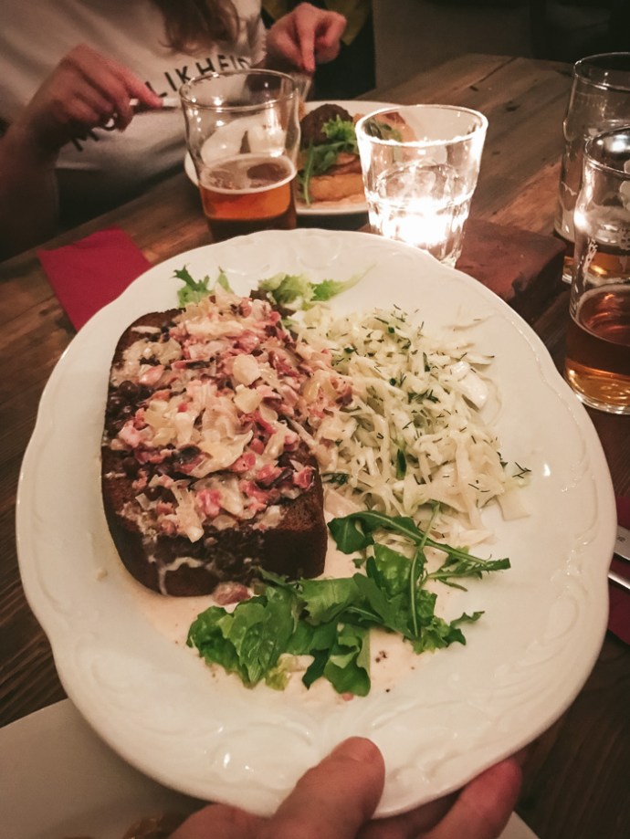 Rye bread and grey peas on a white plate