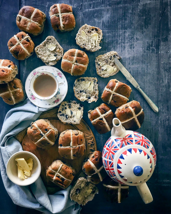 lots of hot cross buns a cup of tea and a teapot