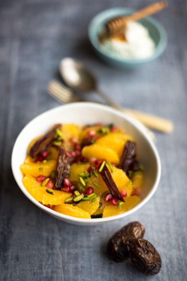 Date and orange fruit salad, some dates and some cutlery