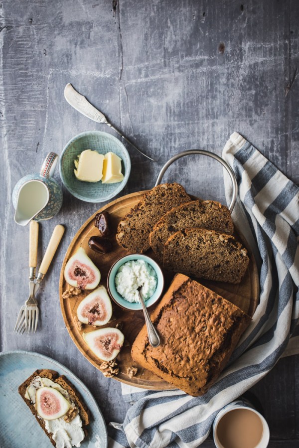 wooden board with date and walnut cake in slices