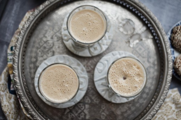 three glasses of date lassi on a tray