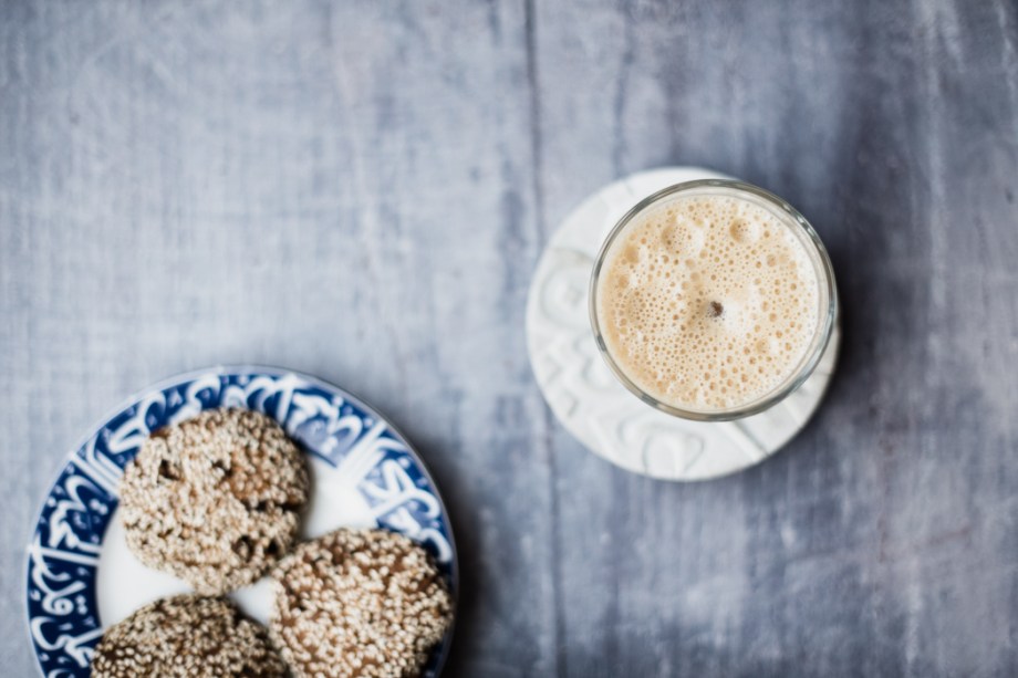 glass of date lassi and plate of biscuits