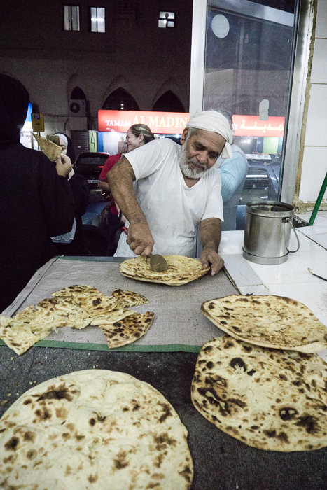 man cutting bread