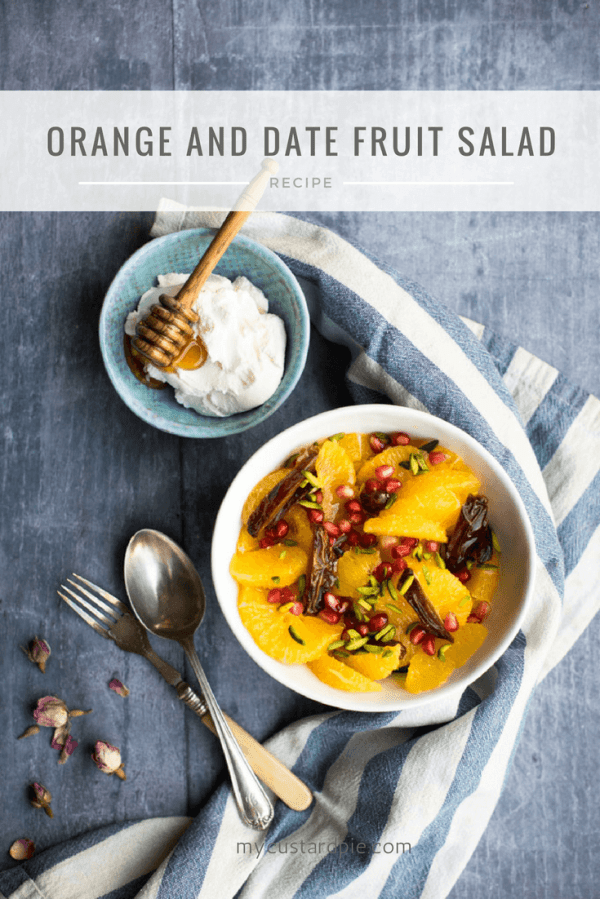 Orange and date salad with a bowl of yoghurt and some cutlery