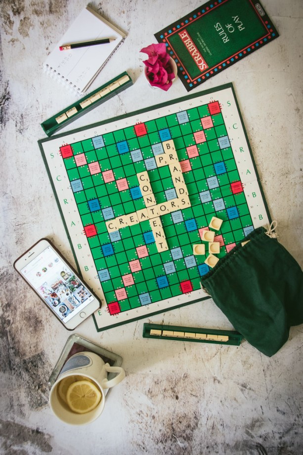 Scrabble board, cup of tea, phone