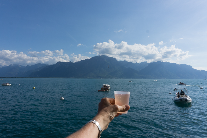 glass of rose wine and lake geneva