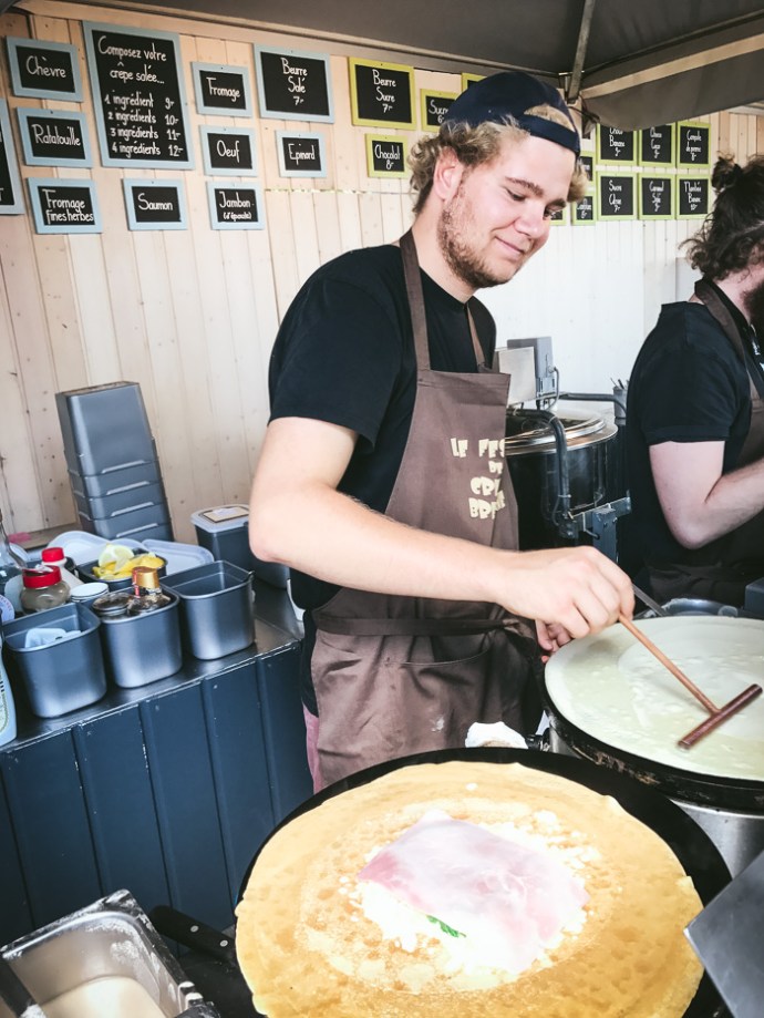 young man making crepes
