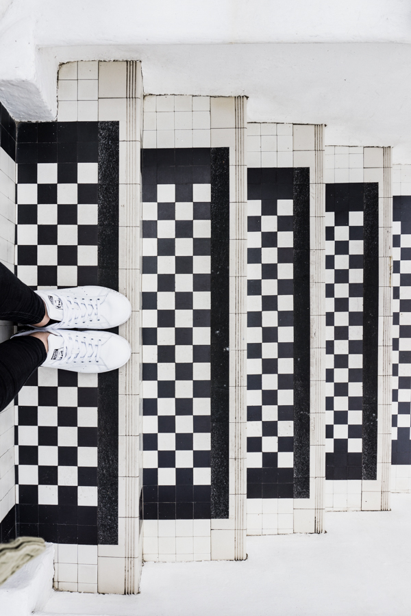 feet on black and white stairs