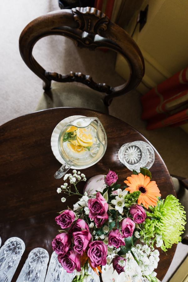 chair and table with flowers and water