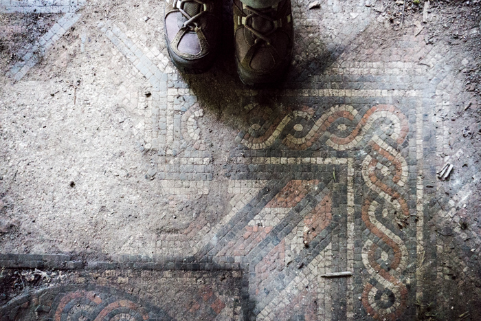 Walking boots by a Roman mosaic