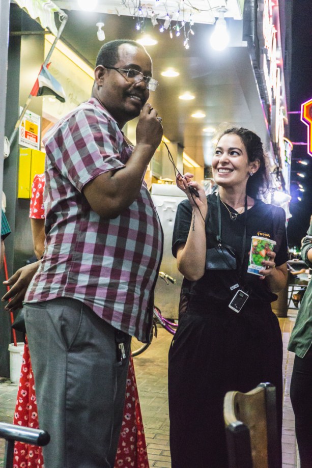 Restaurant owner saying farewell in the street