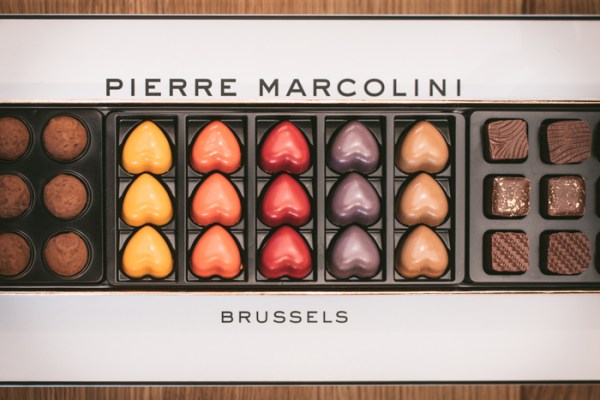 A large box with drawers of A box of Pierre Marcolini chocolates showing heart-shaped ones