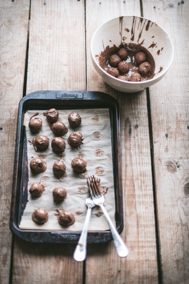 Dipping Tim Tam Truffles into melted chocolate