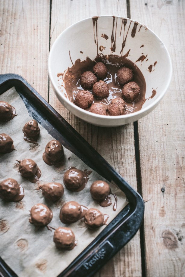 Dipping Tim Tam Truffles into melted chocolate