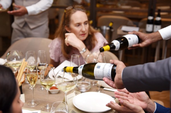 Olivier Leflaive white Burgundy being poured into glasses at Il Borro restaurant