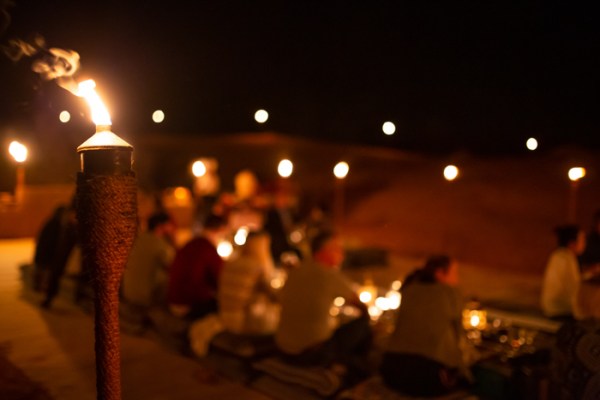 lights around a dinner setting in the desert