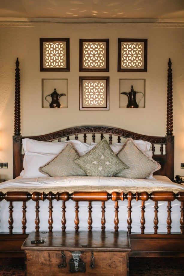 a wooden king sized bed with alcoves and coffee pots