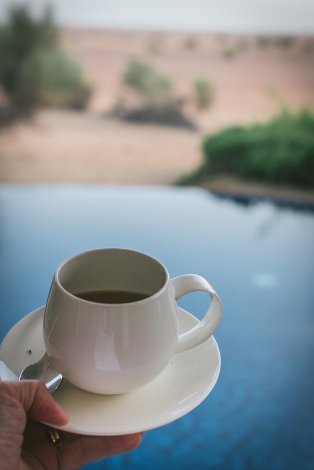 cup of tea with pool in background