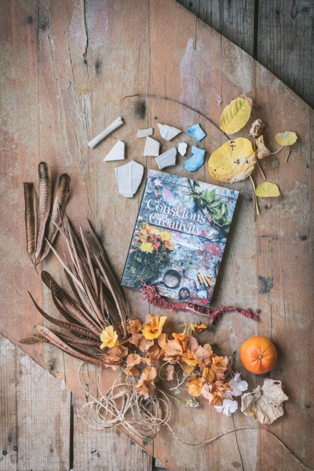 the book conscious creativity on a table with and other bits and pieces