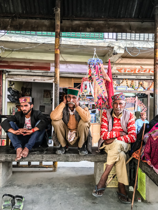 three men at a bus stop