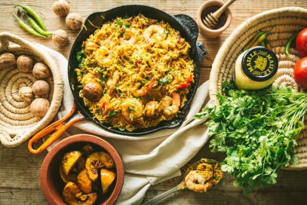 skillet with rice and honey mustard prawns with ingredients coriander and loumi