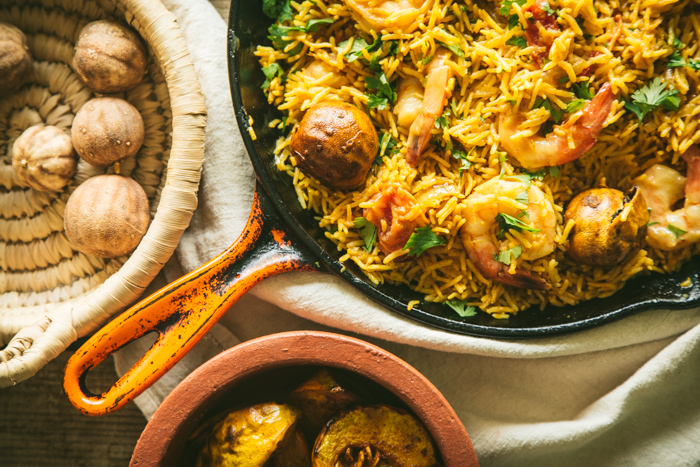 skillet with rice and honey mustard prawns with ingredients coriander and loumi