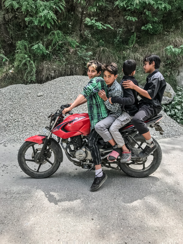 four boys on a motorbik