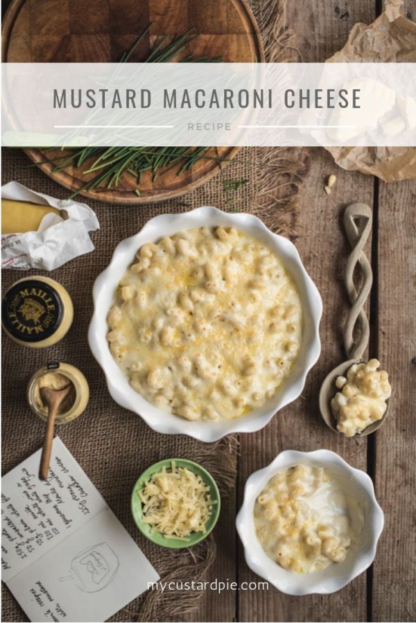 Two bowls of mustard macaroni cheese with a serving spoon