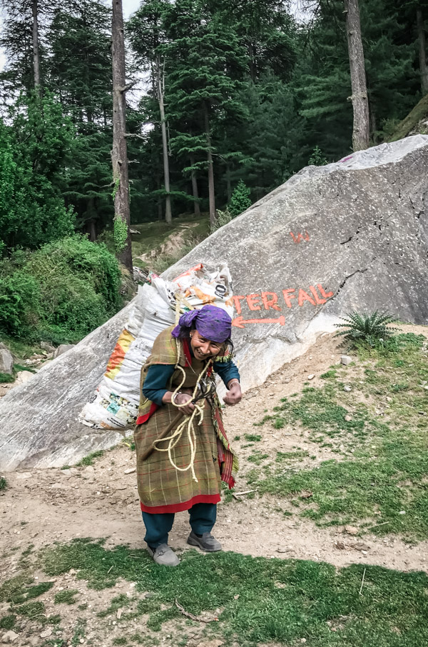 lady in local dress with a load on her back
