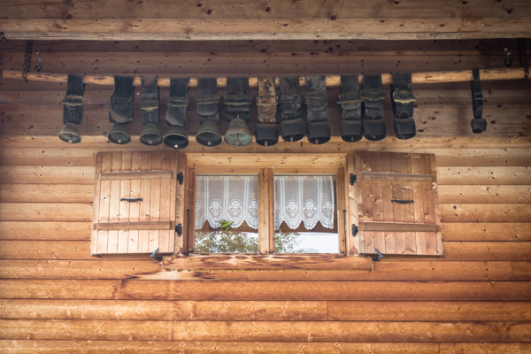 cows bells under the eaves of the farm house