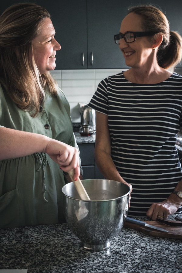 Tiffany and Sally mixing things in the kitchen