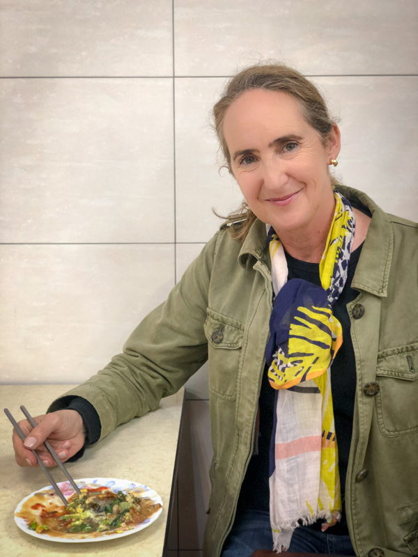 woman eating with chopsticks