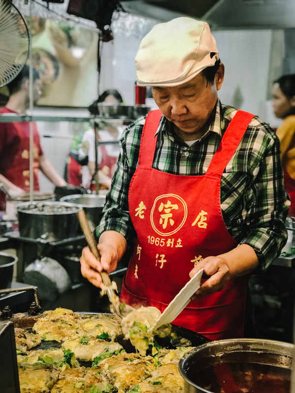 man cooking oyster omelette