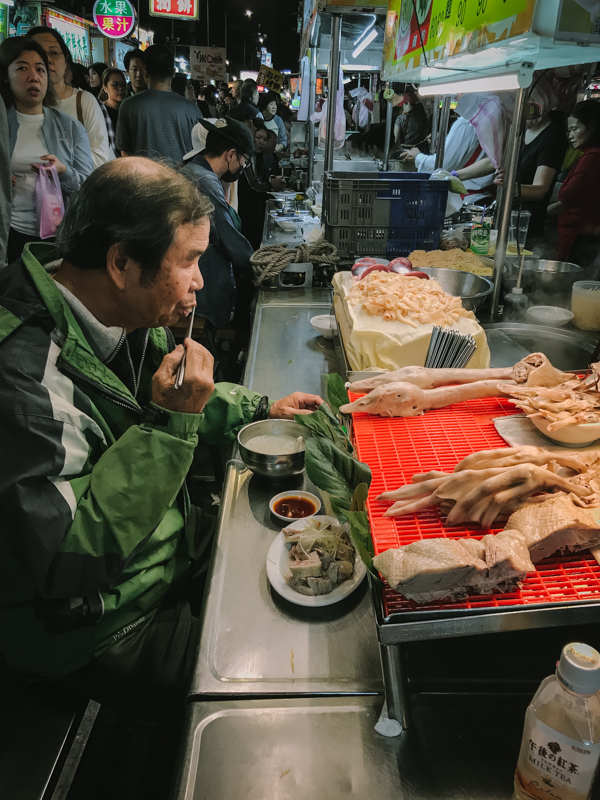man eating at stall