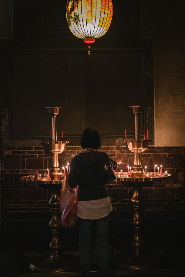 woman making offering in temple