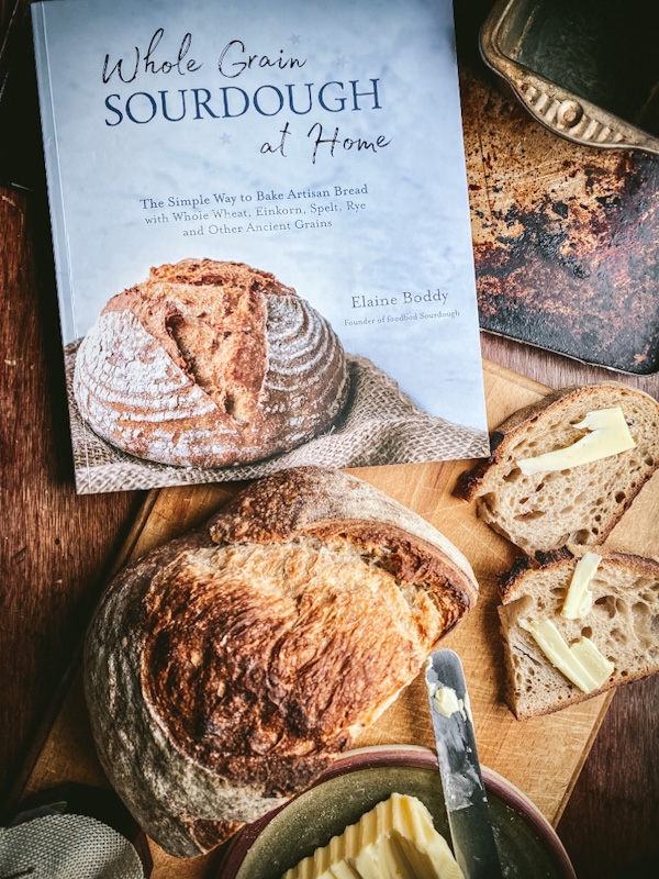 Whole grain sourdough book with bread and butter