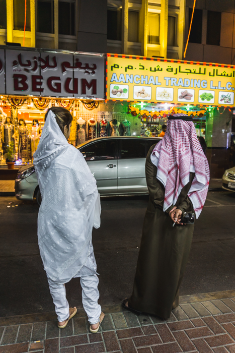 lady in sari and man in arabic clothes