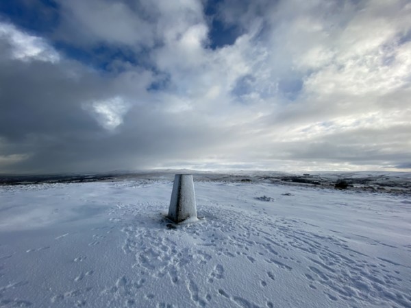 snow on a tor and trig point