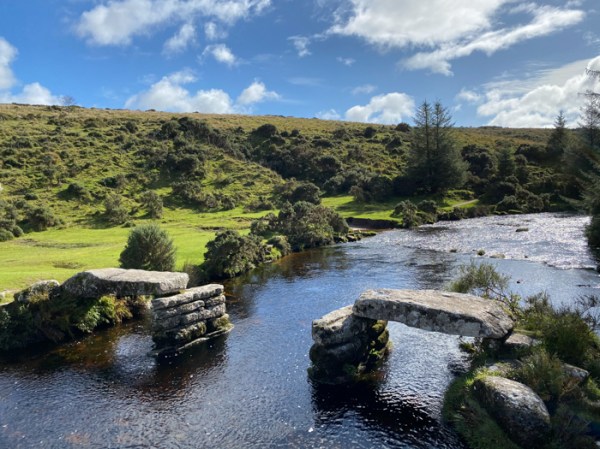 a stone clapper bridge over a river